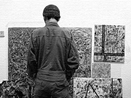 Hidekazu Ishikawa standing among his works during his years as an artist